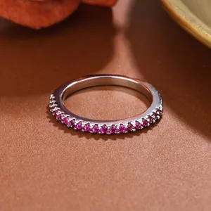 Exquisite macro detail of a silver stackable ring inlaid with half-circle red gemstones