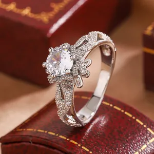 Detailed view of an elegant hollow flower snowflake ring with a brilliant central stone