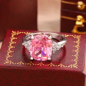 Detailed view of an elegant silver engagement ring with a large pink cushion-cut stone.