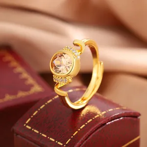 Close-up macro view of an elegant gold-plated ring with a sparkling champagne center stone