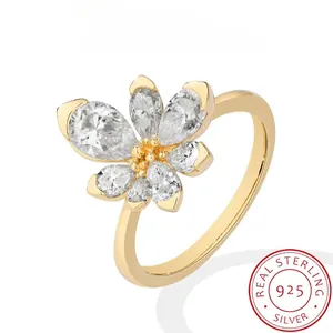 Detailed view showing the sparkling five-petal zircon flower on a golden ring.