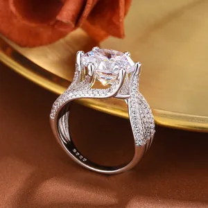 Macro shot of a 5-carat silver ring with a crown six-prong setting and pavé small stones.