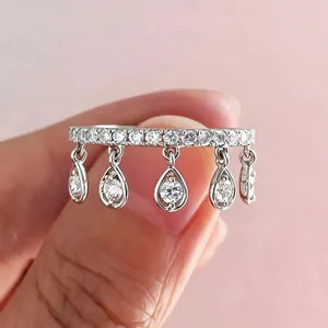 Detail view of luxury silver tassel ring featuring sparkling teardrop zirconia stones