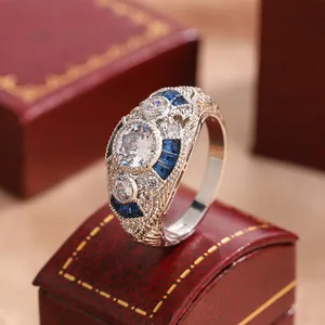 Close-up of a vintage silver ring with blue sapphire accents and sparkling stones.