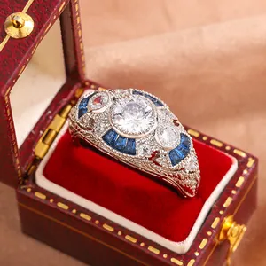 Close-up of vintage art deco ring with blue sapphire and clear stones in red box