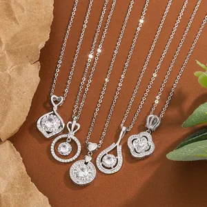 Close-up of assorted silver necklaces with heart and teardrop zircon pendants