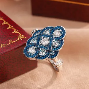 Close-up detail of vintage blue enamel ring with sparkling round cubic zirconia stones