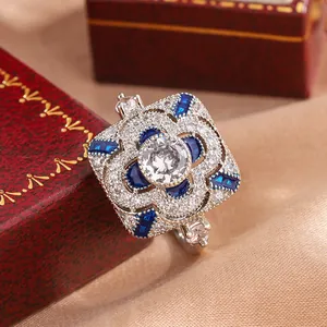 Detailed close-up of a vintage silver ring with clear and blue cubic zirconia stones