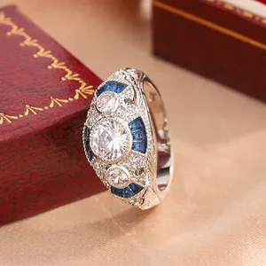 Detailed macro view of a vintage silver-toned ring with brilliant blue and clear stones