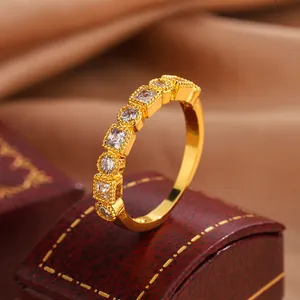 Macro detail of vintage gold-plated ring with alternating round and square stones