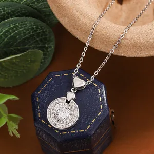 Close-up view of heart pendant necklace with shimmering zircon stones on a gift jewelry box.