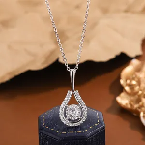 Detailed macro shot of an elegant teardrop zircon pendant necklace with silver chain