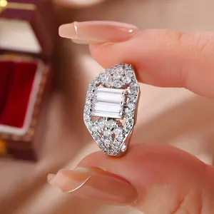 Close-up detail of a silver-toned ring encrusted with rectangular and round zircons