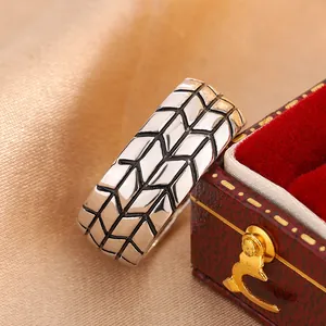 Detailed view of a 6mm men's band ring with a unique tire tread diamond pattern