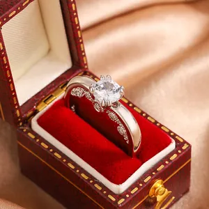 Detailed macro view of an elegant silver-colored ring with a large clear zircon in a red box.