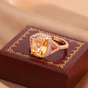 Detailed close-up view of a rose gold plated ring set with a radiant-cut yellow zircon