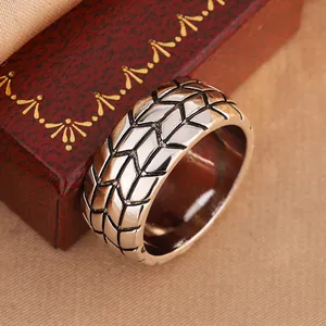 Detailed macro view showing the textured tire tread pattern on a 6mm men's metal ring