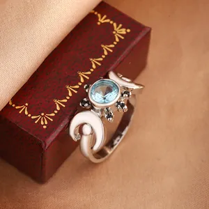 Detailed macro view of a silver-toned moon design ring with a central blue zircon stone
