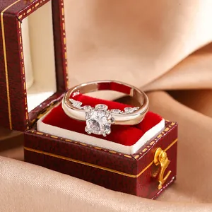 Detail view of a silver ring with large zircon and heart accents in a luxury jewelry box
