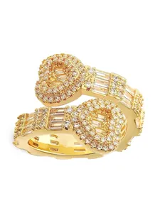 Detailed view of gold iced-out ring with heart-shaped clusters and baguette stones