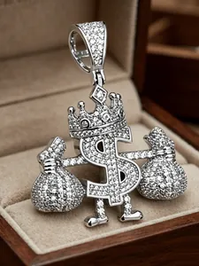 Close-up detail of an iced-out dollar sign pendant with crown and money bags decoration