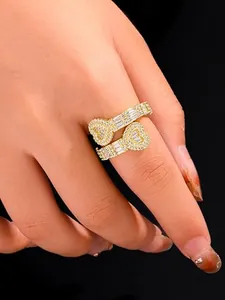 Detailed close-up of a hip-hop style gold plated heart ring with pavé rhinestones