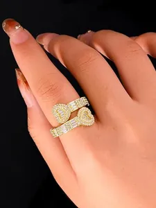 Exquisite close-up view of a gold iced-out heart hip-hop ring worn on a female hand