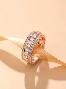 Detailed macro shot of 18K rose gold plated ring band encrusted with white crystals