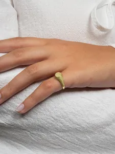 Detailed view of a gold hip hop signet ring paved with sparkling yellow zircons on hand