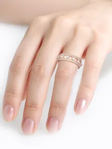 Detailed close-up of a hollowed rose gold ring with sparkling pavé diamonds