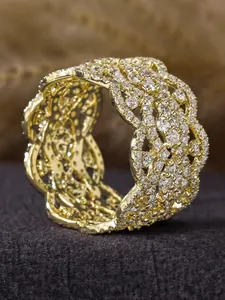 Close-up of a wide gold-colored ring with intricate micro-pave zircon hollow weaving