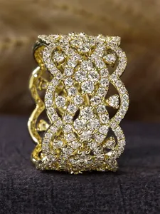Close-up macro of an intricate gold filigree ring with sparkling micro-pave stones