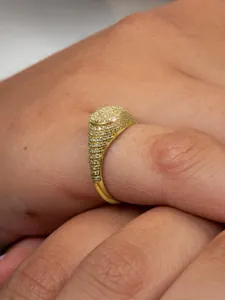 Detailed close-up of a gold-plated oval hip hop ring with full 5A cubic zirconia