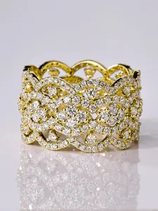 Detailed macro view of a luxury gold wide band ring with intricate pavé cubic zirconia