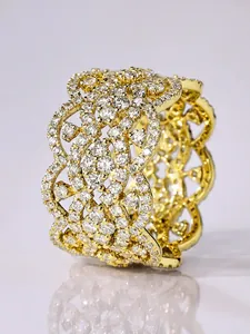 Macro view of elegant gold-toned filigree ring featuring micro-pave white zircon stones