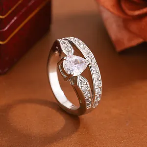 Close-up detail of fashion women ring with pear-shaped zircon and elegant pave setting