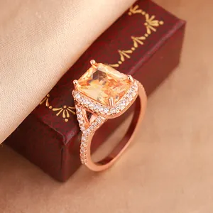 Exquisite rose gold engagement ring detail featuring a large emerald cut yellow zircon stone.