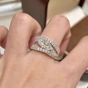 Detailed macro view of a silver marquise-cut cubic zirconia ring with micro-pave bands.