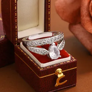 Detailed view of an elegant pear-cut cubic zirconia ring inside a red velvet gift box