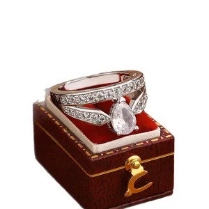 Elegant silver-tone cocktail ring with pear-shaped cubic zirconia in a red velvet gift box