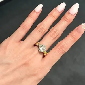Elegant gold halo ring with a sparkling round centerpiece shown on a model hand