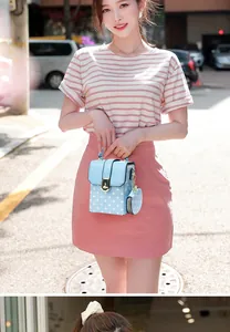 Detailed shot of a light blue polka dot crossbody bag set worn by a model in sunshine