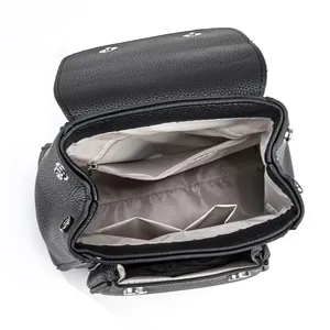 Interior view of black leather bag showing lining and pockets for organization.