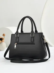 Elegante zwarte kunstlederen handtas met goudkleurige details en handvatten