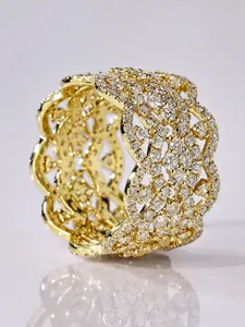 Close-up of gold five-leaf flower bangle with micro-paved sparkling crystals.