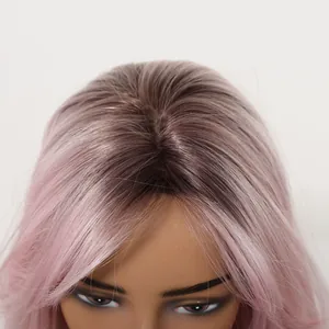 Detailed view of the crown and hairline of a pink ombre synthetic long curly wig
