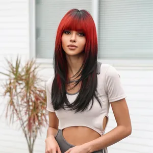 Detailed view of red and black ombre synthetic wig with bangs and layered hair ends