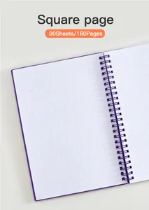 Detalle de cuaderno de espiral A5 con papel cuadriculado y recuento de 80 hojas.