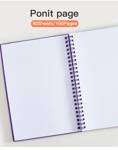 Vista detallada de las páginas de cuadrícula de puntos en un cuaderno de espiral A5 púrpura
