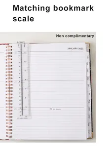 Detail view of 2023 planner featuring monthly tabs and a transparent bookmark ruler.